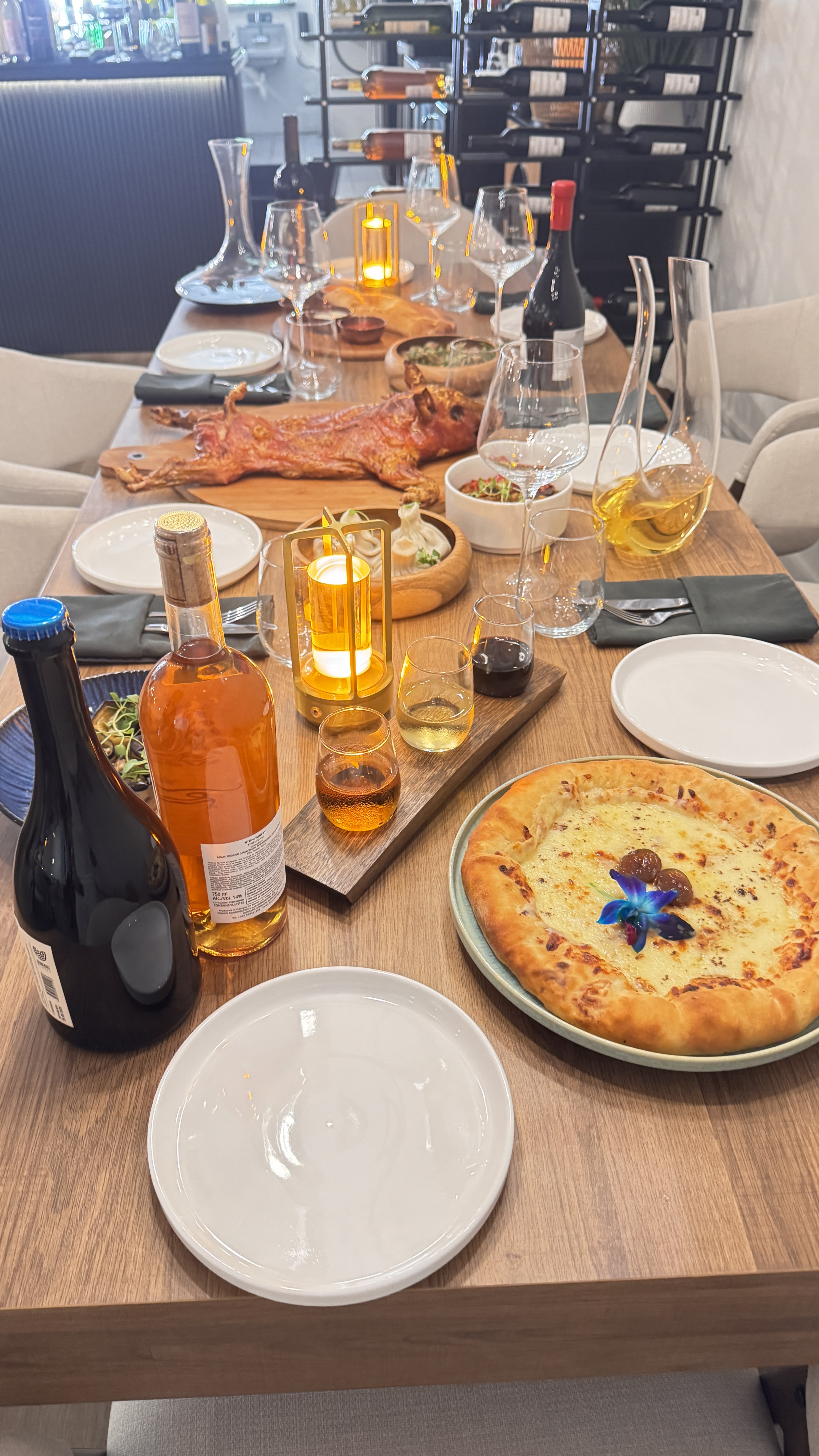 A traditional Georgian spread of khachapuri, khinkali, and wine at BEKA